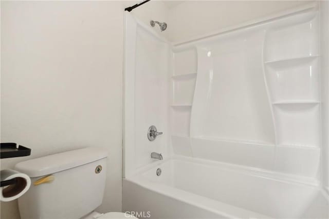 bathroom with washtub / shower combination and toilet