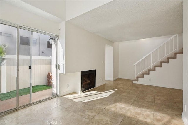 unfurnished living room with a textured ceiling