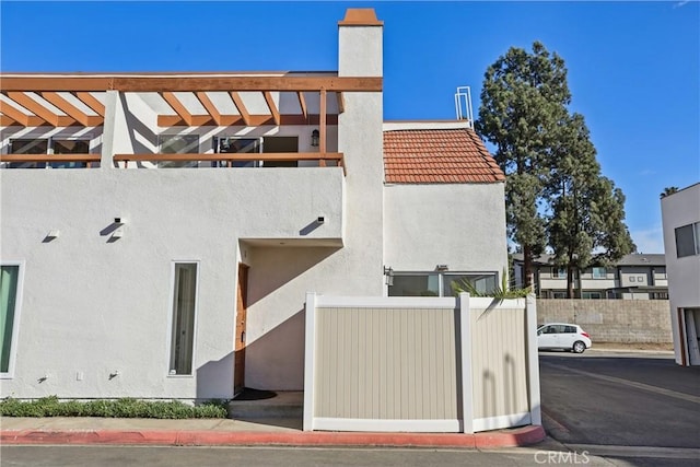 view of side of property featuring a pergola