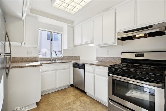 kitchen featuring light tile patterned flooring, stainless steel appliances, white cabinets, and sink