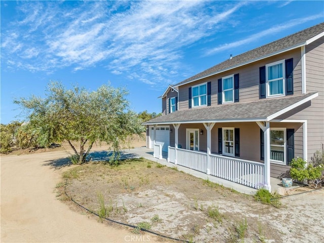 view of property exterior with a porch and a garage