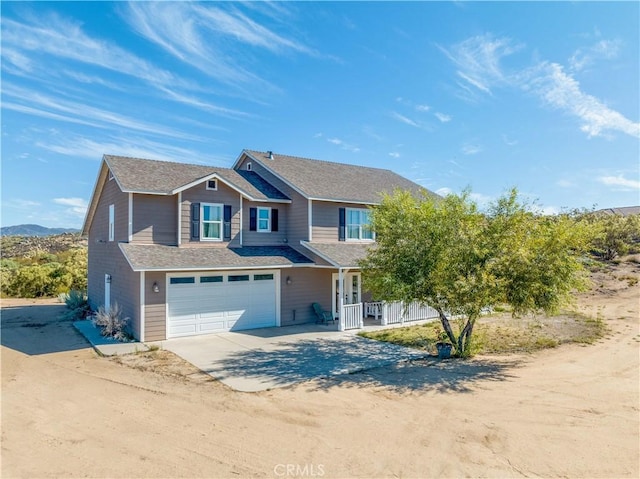 view of front of home with a garage and a mountain view