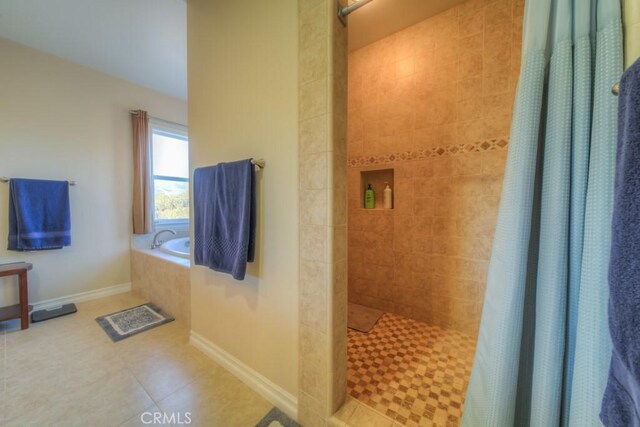 bathroom with a shower with curtain and tile patterned flooring