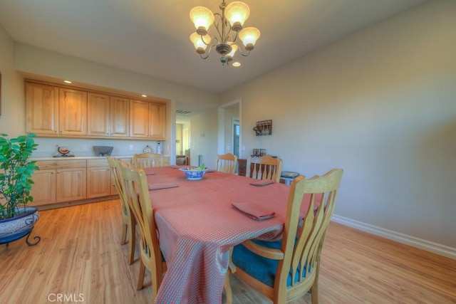 dining room featuring light hardwood / wood-style flooring and a chandelier