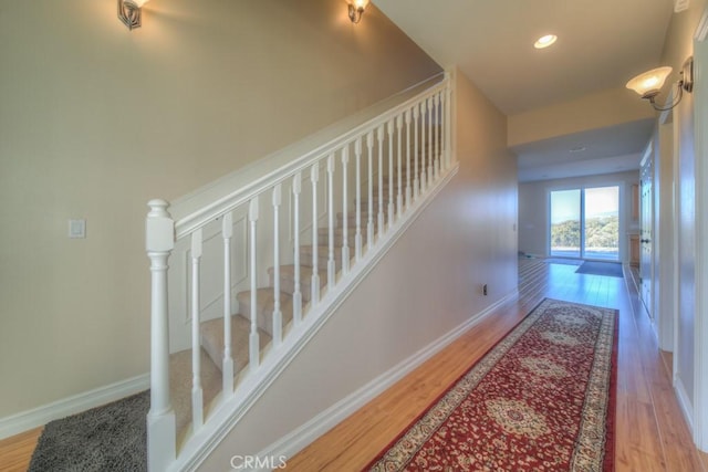 stairs featuring wood-type flooring