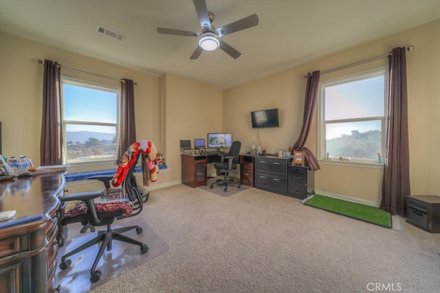 carpeted office featuring ceiling fan