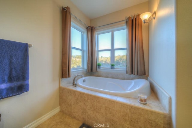 bathroom with tile patterned flooring and a relaxing tiled tub