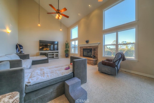 living room with ceiling fan, a fireplace, carpet floors, and high vaulted ceiling