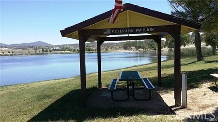 surrounding community with a water and mountain view, a gazebo, and a yard