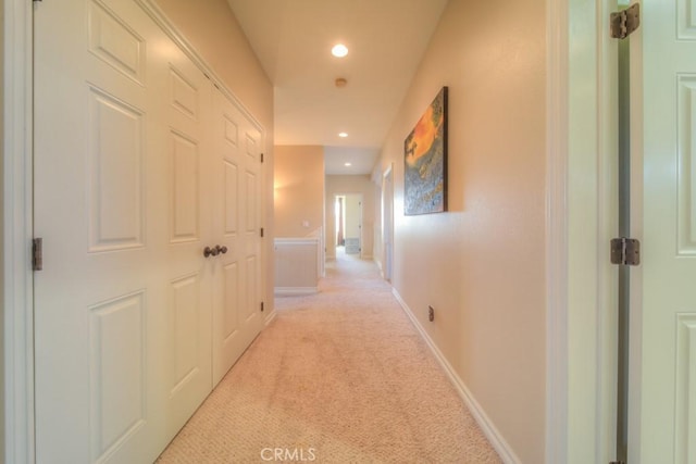 hall featuring light colored carpet