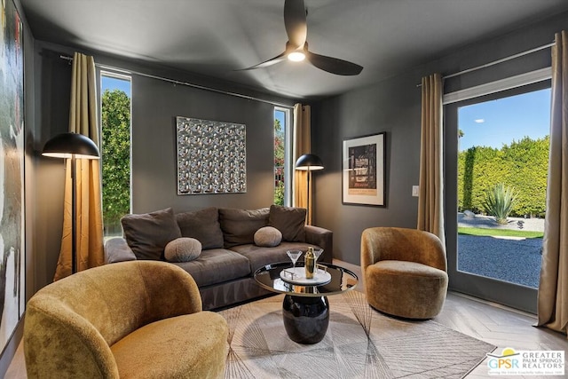 living room featuring ceiling fan and parquet floors