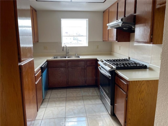 kitchen featuring light tile patterned floors, decorative backsplash, appliances with stainless steel finishes, and sink