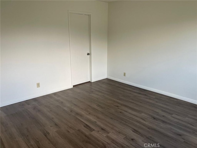 spare room with dark hardwood / wood-style flooring