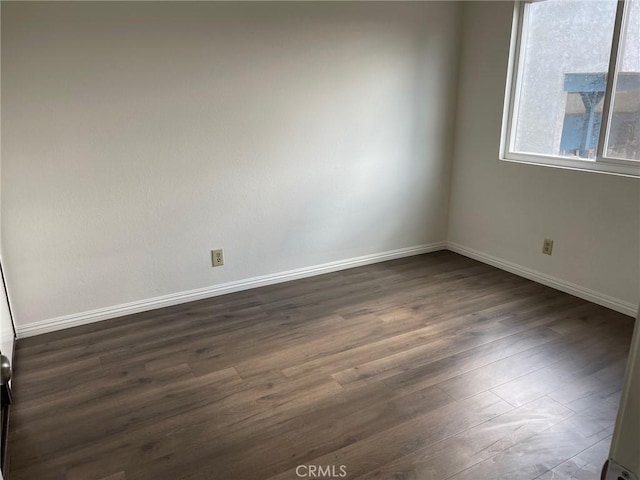 spare room featuring dark hardwood / wood-style flooring