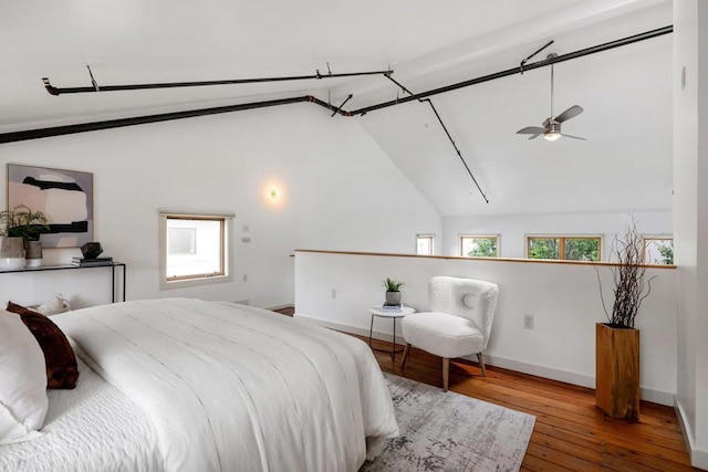 bedroom with wood-type flooring and vaulted ceiling