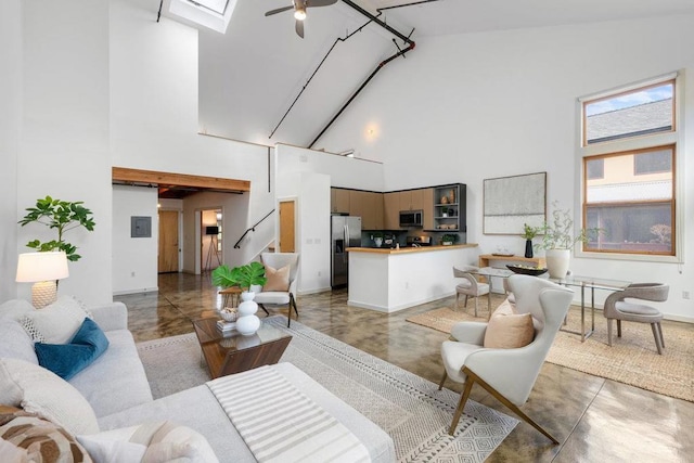 living room with high vaulted ceiling, ceiling fan, and concrete flooring