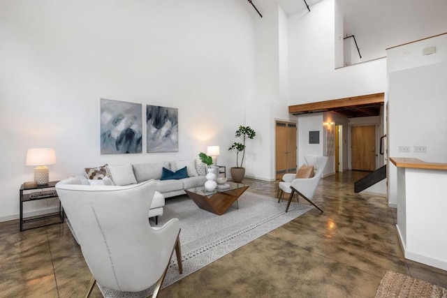 living room featuring a towering ceiling