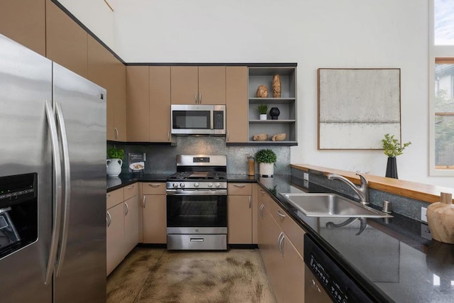 kitchen with decorative backsplash, appliances with stainless steel finishes, sink, and dark stone countertops