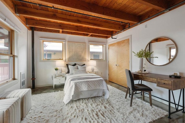 bedroom with wooden ceiling, a closet, beam ceiling, and multiple windows