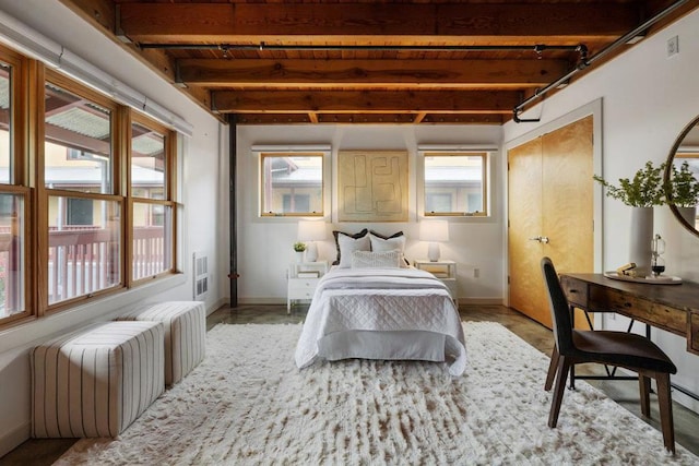 bedroom featuring beam ceiling and wooden ceiling