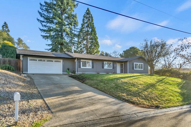 ranch-style home featuring a front lawn and a garage