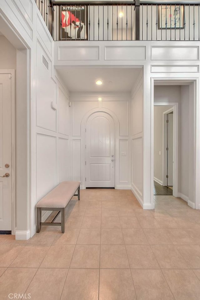 tiled entryway featuring a high ceiling