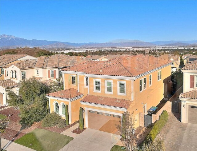 mediterranean / spanish-style house with a garage and a mountain view