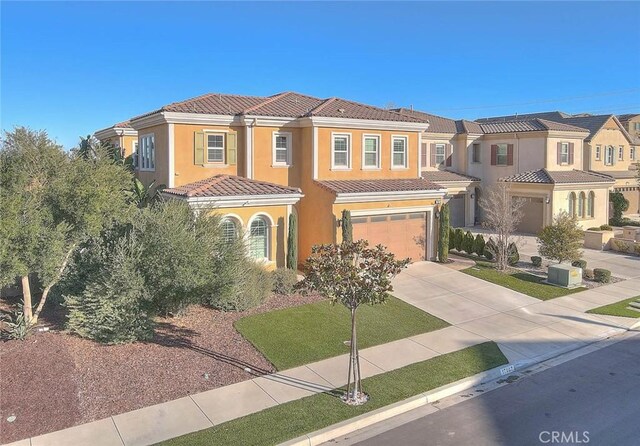 mediterranean / spanish-style home with a garage