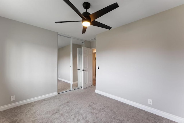 carpeted empty room with ceiling fan