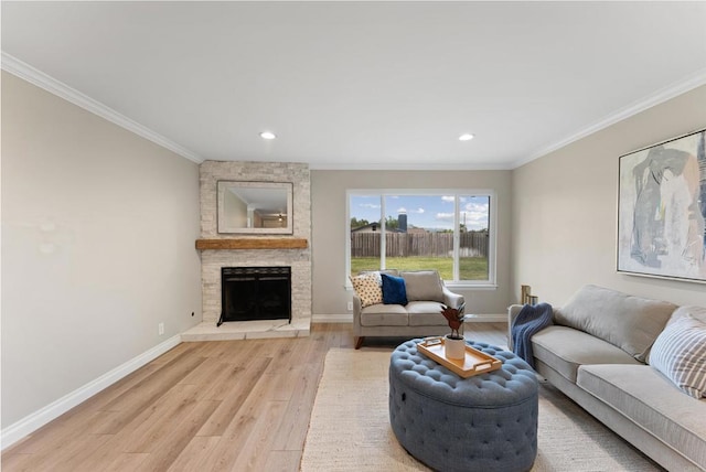 living room featuring light hardwood / wood-style flooring, ornamental molding, and a stone fireplace