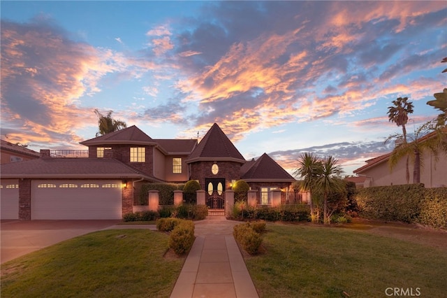 view of front of house featuring a lawn and a garage