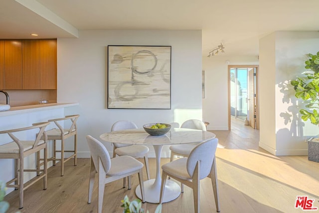 dining area with light wood-type flooring