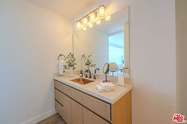 bathroom featuring hardwood / wood-style flooring and vanity