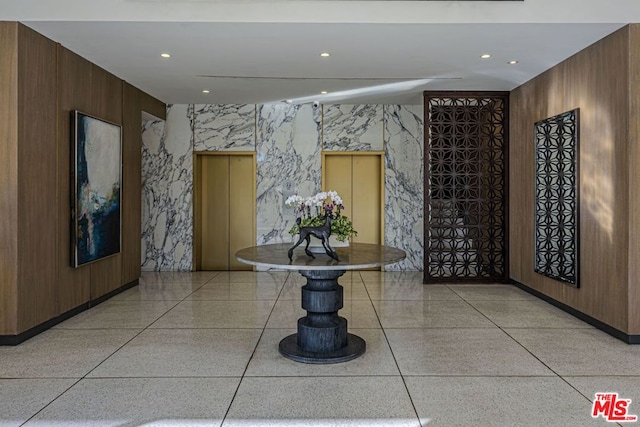 corridor with wood walls and elevator