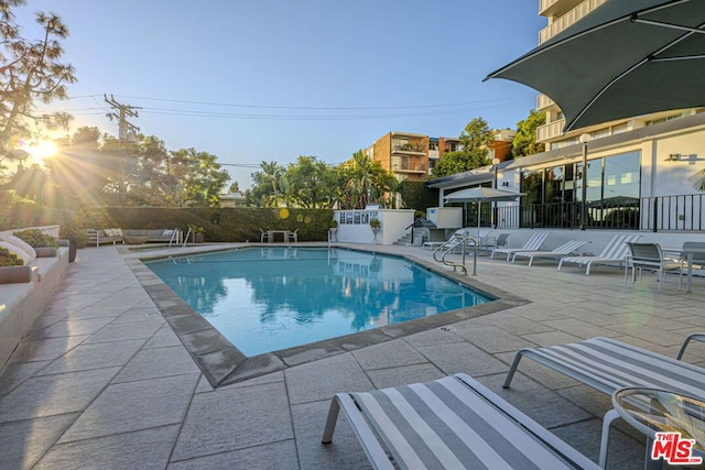 view of swimming pool with a patio