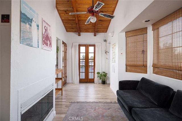 interior space featuring french doors, vaulted ceiling with beams, wood ceiling, light wood-type flooring, and ceiling fan