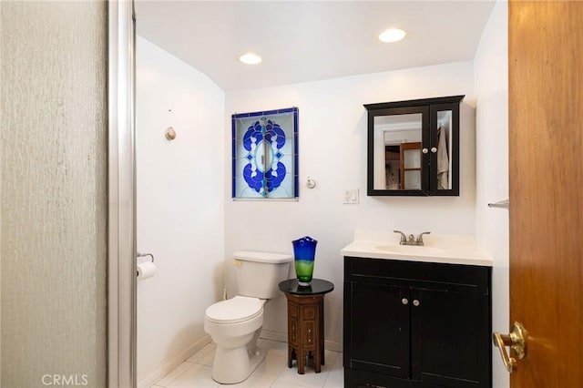 bathroom with tile patterned flooring, vanity, and toilet