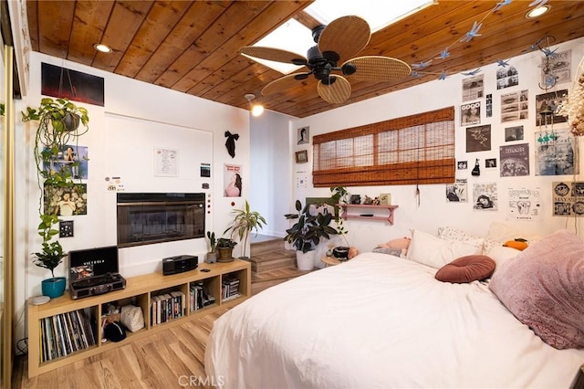 bedroom featuring hardwood / wood-style flooring, ceiling fan, and wooden ceiling