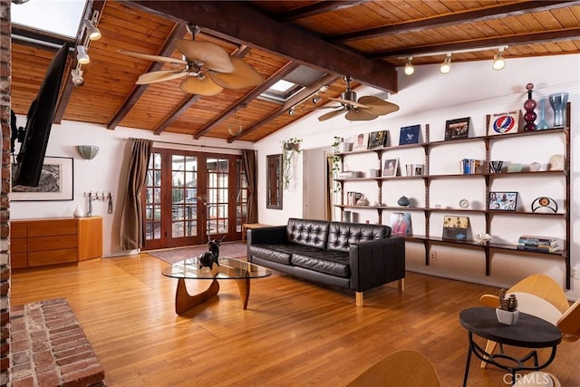 interior space with light hardwood / wood-style floors, wooden ceiling, french doors, and vaulted ceiling with skylight