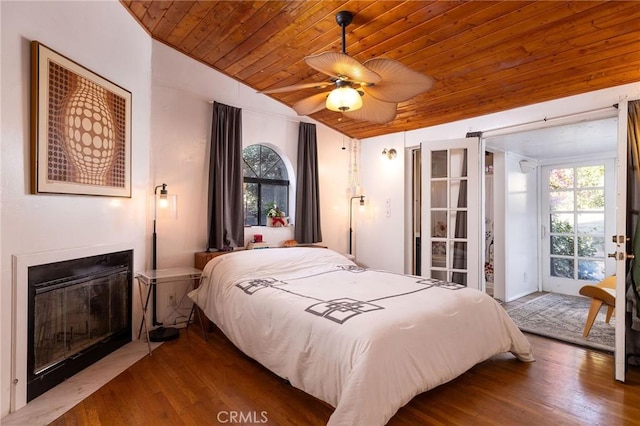 bedroom featuring vaulted ceiling, access to outside, wooden ceiling, hardwood / wood-style flooring, and ceiling fan