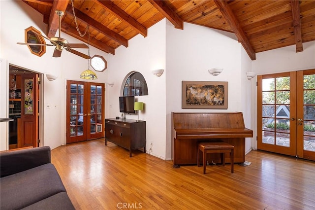 living room with french doors, wood ceiling, high vaulted ceiling, light hardwood / wood-style flooring, and beam ceiling