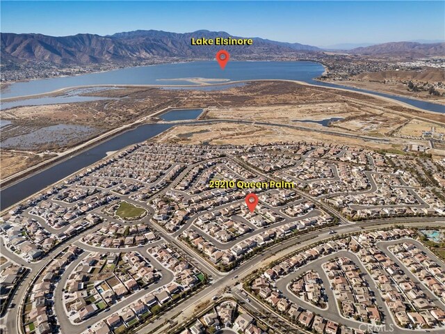 birds eye view of property with a water and mountain view