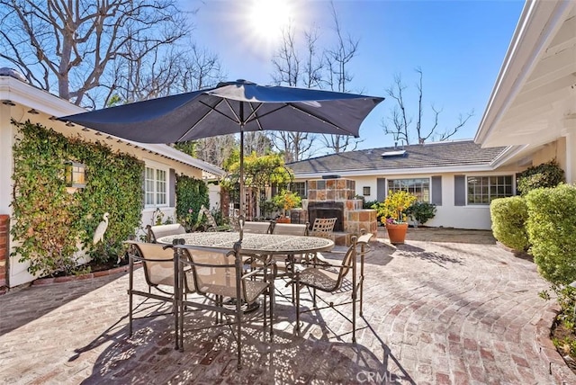 view of patio featuring an outdoor stone fireplace