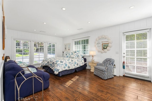 bedroom with dark wood-type flooring and multiple windows