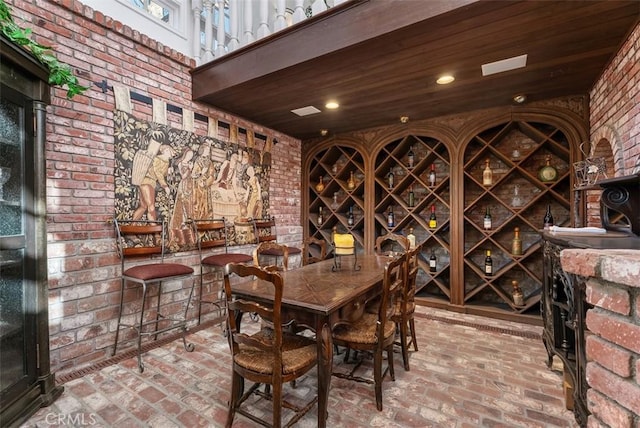 wine cellar featuring wooden ceiling and brick wall