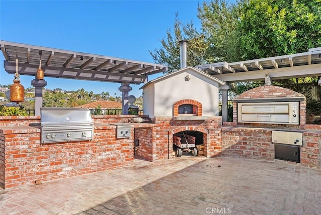 view of patio / terrace with a pergola and area for grilling