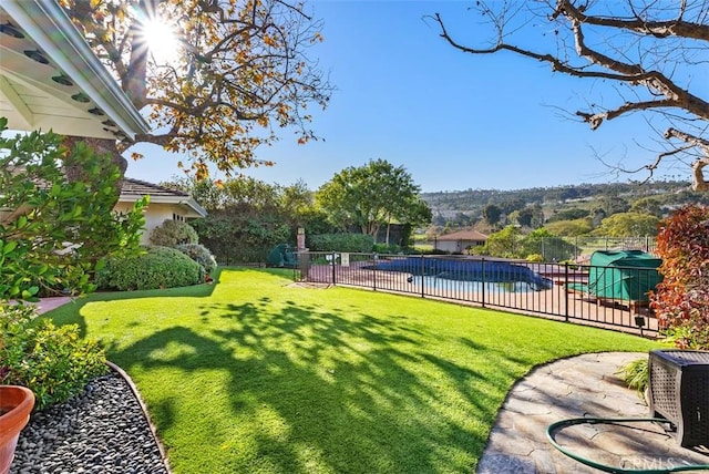 view of yard with a fenced in pool