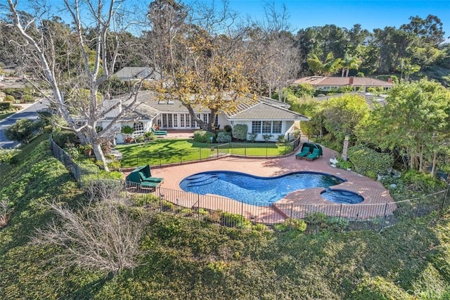 view of pool with an in ground hot tub, a lawn, and a patio