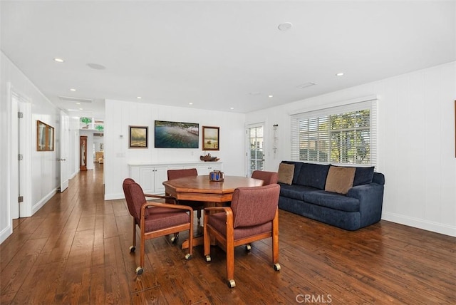 dining space with dark hardwood / wood-style flooring