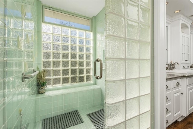 bathroom featuring an enclosed shower and vanity